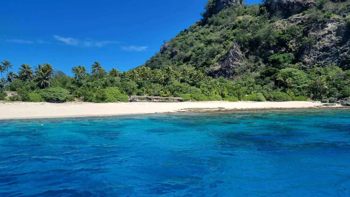 The jungle-backed beach on Monuriki, the Cast Away island visited on Mamanuca Islands tours from Port Denarau, Fiji